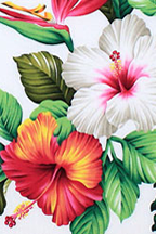 Brightly colored hibiscus, bird of paradise and orchids amongst ferns and leaves. 