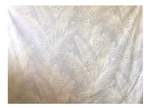 White on white  All-Over. Tonal, large-scaled tropical leaves and ferns with little clusters of plumeria (frangipani).